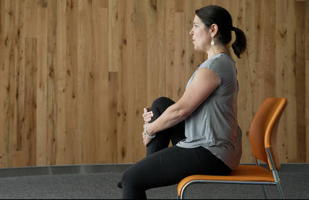 Certified Yoga Instructor and Oncology Dietitian Nicole Parker, LD, RD, RYT200, doing chair yoga