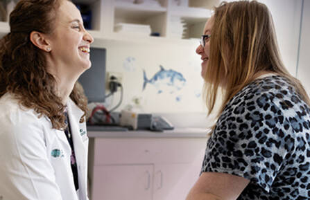 Pediatric Dermatologist Jillian Rork, MD, laughing with a patient