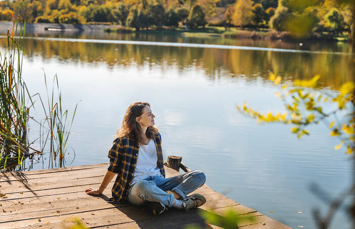 Woman sitting outside in the fall