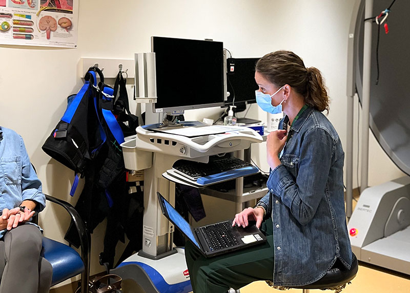 Julia Noreika, PT, DPT, asking patient Linda Post questions about her dizziness