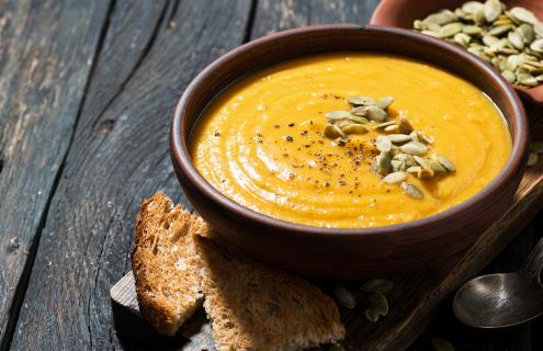 Bowl of pumpkin soup with pumpkin seeds