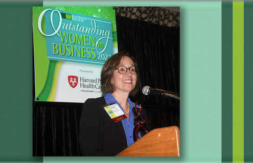 Wendy Fielding stands at the podium to receive her award.