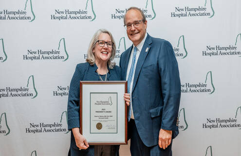 Susan Reeves stands with Steve Ahnen holding award