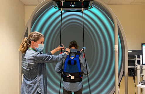 Julia Noreika working with a patient on a Bertec machine