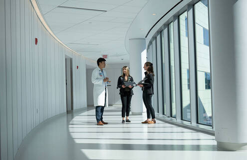 Cardiology colleagues talking in a hallway