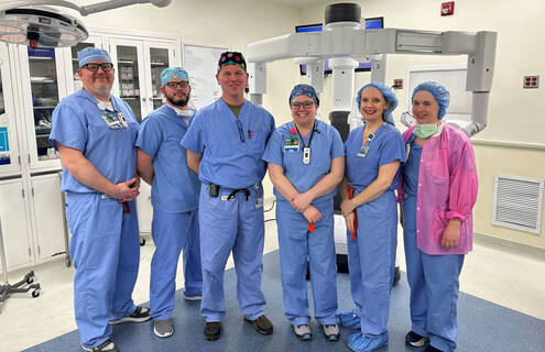 Photo of medical professionals with the robotic surgical platform