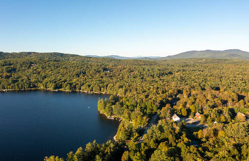 View of lake and home in rural setting