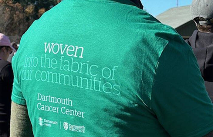 Back of man wearing a Darmouth Health volunteer t-shirt 