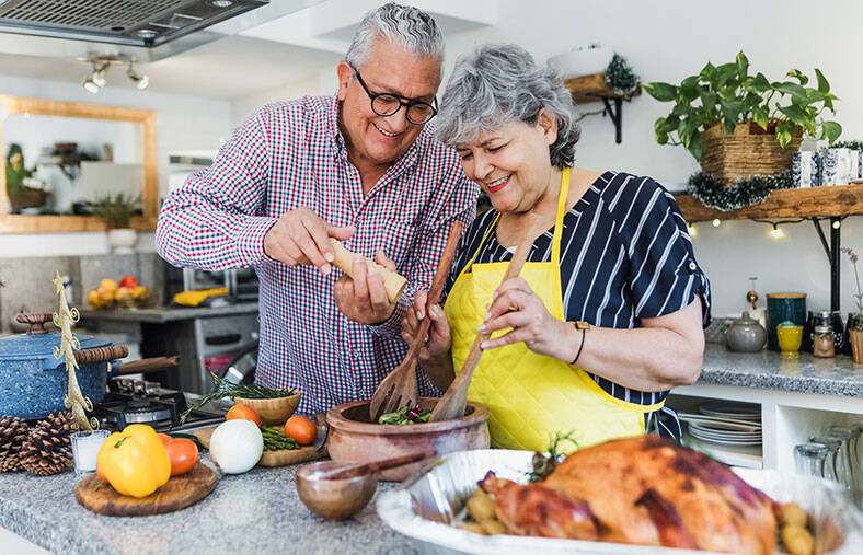 Older couple cooking Thanksgiving dinner